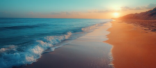 Poster - Serene beach sunset with gentle waves and soft light blue hues reflecting on the shoreline at dusk