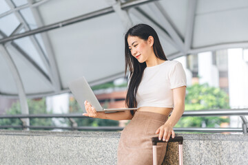 Wall Mural - Business freelance asian woman using laptop computer sitting at outdoor