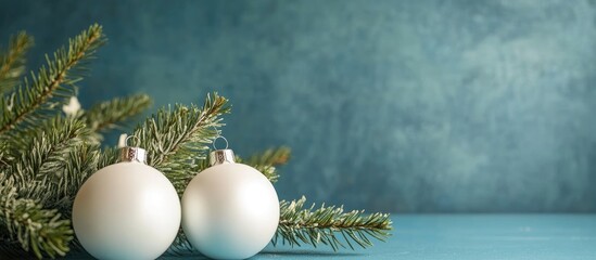 Poster - Elegant Christmas scene featuring white ornaments and fir spruces against a textured blue backdrop with space for festive text or messages.