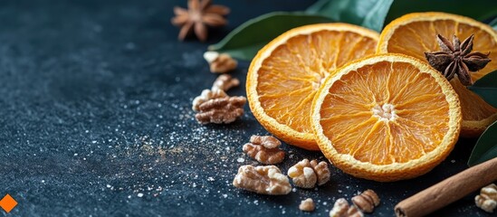Poster - Dried orange slices with cinnamon and walnuts on a dark stone background creating a warm seasonal atmosphere