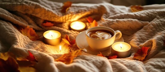 Poster - Cozy autumn scene with coffee cup and candles surrounded by colorful leaves on a soft bed highlighting warmth and relaxation