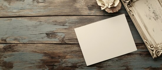 Poster - Blank card on rustic wooden surface with decorative frame and flower accent perfect for text or personalized messages