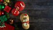 © littlepigpower - Top view of donut and Christmas decorations on wooden background