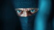 ©  lukaPixMedia - A close-up of a person's intense eyes visible through a black mask, conveying a sense of mystery and intrigue, captured in cold, moody lighting.