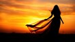 © jaeng - Graceful female silhouette in a flowing dress standing against a colorful sunset background, mystical, concept, atmosphere