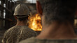 © Nattapol - Workers observing fire in industrial setting, wearing helmets and uniforms. scene conveys sense of vigilance and safety in hazardous environment