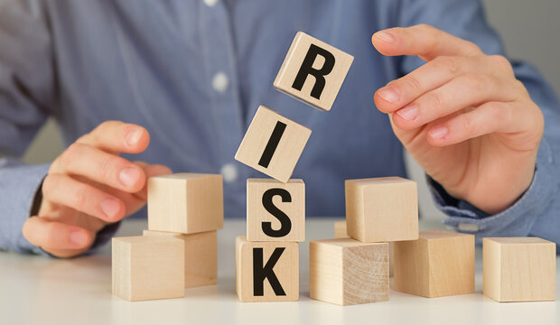 Risk Word on Wooden Tile Block and business woman