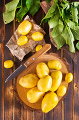 Wall Mural - raw young potatoes on a table