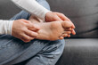 © Yura Yarema - Close up of young woman with scratch feet, itch foot, problem itchy skin sitting on couch at home, dermatitis from fungus, fungal bacterial infection, allergic reaction, eczema. Foot care concept