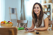 © Dragana Gordic - Smiling Woman Sitting at Table with Fruits in Family Home