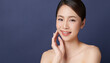 © kitthanes  - Beautiful young asian woman with clean fresh skin on blue background, Face care, Facial treatment, Cosmetology, beauty and spa, Asian women portrait.