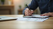 © FundFinder - person signing a document
