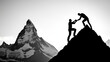 © Nattapol - Silhouette of man helping his friend reach top of mountain, showcasing teamwork and determination against stunning backdrop