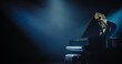 © Gorodenkoff - Black Grand Piano with a Microphone Standing on a Concert Stage Under Spotlights. Music Instrument Ready to Be Used by an Extravagant Music Artist and Singer