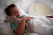 © peopleimages.com - Boy, child and sleeping in bed with bunny, toys and tired with rest, dream and wellness in family home. Kid, rabbit and plush doll in bedroom with eyes closed, exhausted and comfort with hug at house