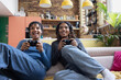 © ReeldealHD images - Female friends playing video game sitting on floor in loft apartment