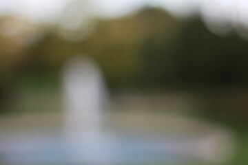 Wall Mural - a dreamy view of a water fountain spounting in the park.