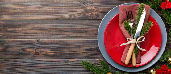 Sticker - Christmas table place setting with christmas decor and plates, kine, fork and spoon. Christmas holiday background. Top view with copy space