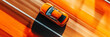 © StockUp - A stunning aerial view of a vibrant orange car in motion.