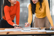 © kenchiro168 - Collaborative women discussing business strategies with charts and documents. Engaged in productive meeting, showcasing teamwork and creativity