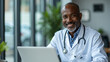 © MOTOKO Stock - Healthcare professional: Black doctor using laptop and stethoscope in hospital office for medical research and cardiology