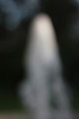 Wall Mural - a dreamy view of a water fountain spounting in the park.