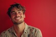 © AI Photo Stock - Handsome Man Smiling Against Red Background - Happy, confident, casual man with a beaming smile, against a vibrant red backdrop.  Joy, confidence, style, summer, fashion.