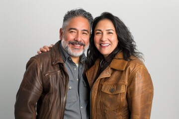 Canvas Print - Portrait of a happy latino couple in their 30s sporting a classic leather jacket in plain white digital canvas