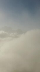 Wall Mural - flying above the clouds. aerial view of clouds at sunrise. traveling by air perfect background. vert