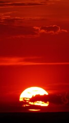 Wall Mural - timelapse with dramatic red sunrise on dark cloudy sky. vertical video