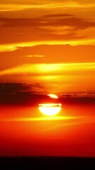 Wall Mural - timelapse with dramatic red sunrise on dark cloudy sky. vertical video