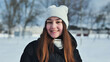 © Довидович Михаил - Happy schoolgirl posing in winter attire and smiling in snowy park during photo session