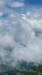 Wall Mural - aerial view on caucasus mountains under epic moving clouds, kabardino-balkaria, russia. vertical vid
