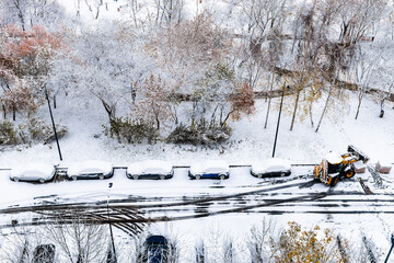 Wall Mural - aerial view of the first snow covered parked cars