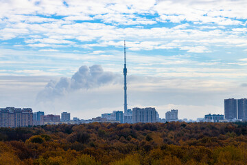 Wall Mural - blue cloudy sky over city block and park in autumn