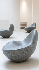 Wall Mural - Modern stone chairs in a minimalist space, designed for comfort and aesthetic appeal.