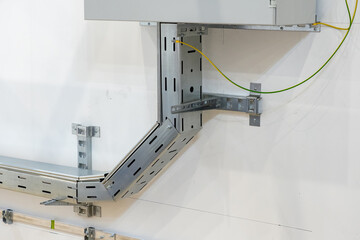Poster - steel cable channel near power panel. fragment electrical cabinet hanging on wall. cable channel for