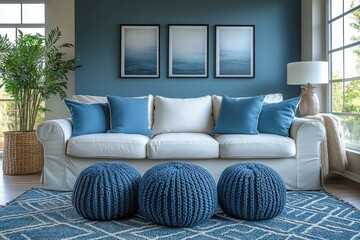 Elegant modern living room interior design featuring a cozy white sofa with blue throw pillows, complemented by stylish decor elements including artwork and poufs.