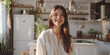 © Felix - young woman sitting in the kitchen and smiling Generative AI