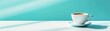 © soysuwan123 - A serene image of a white coffee cup resting on a light surface, set against a soothing turquoise background, evoking calm and comfort.