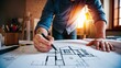 © lastfurianec - A male engineer draws a drawing of a house.