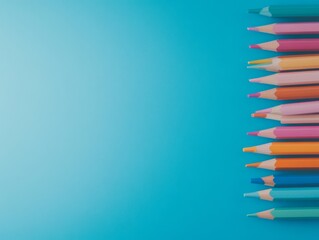 Poster - Vibrant colored pencils are neatly stacked on a light blue surface, showcasing a variety of hues and an orderly arrangement that inspires creativity and focus