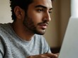 © claudunia - Close-up of a man using a laptop.