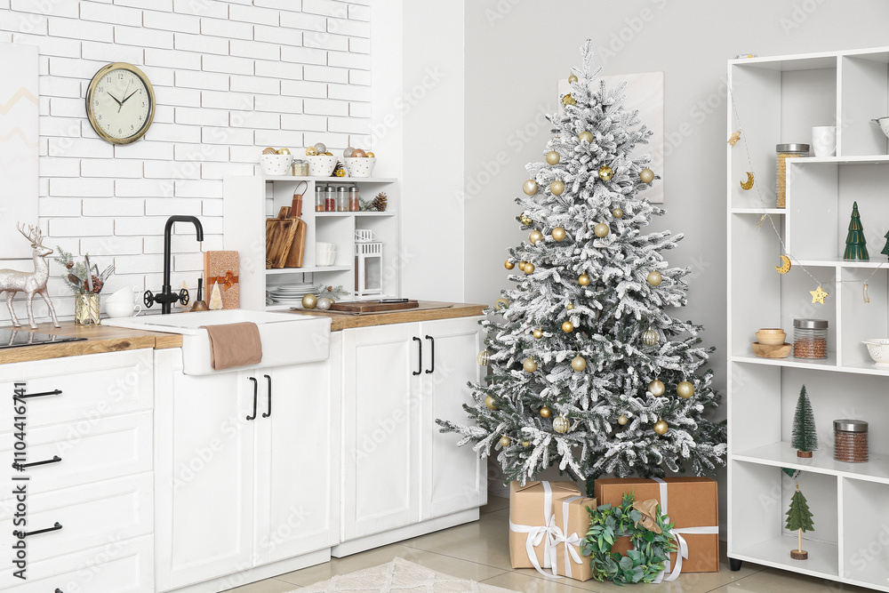 Interior of light kitchen with counters, Christmas tree and shelves