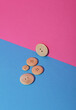 © splitov27 - Set of wooden buttons on blue pink background