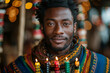 © Мария Фадеева - Portrait of a man celebrating Kwanzaa, holding a Kinara with colorful candles, surrounded by festive decor and warm lighting.