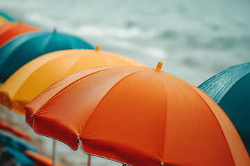 Wall Mural - Colourful beach umbrellas arranged on the beach, captured with soft lighting