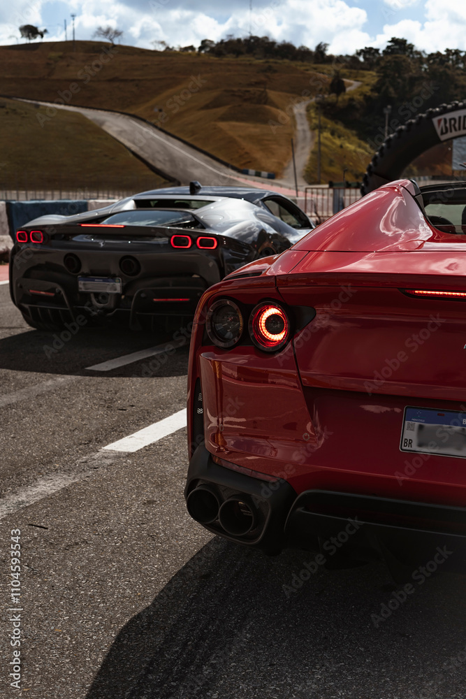 Super Cars Rear View Ferrari 812 GTS and SF90 Stradale on a racetrack, Two modern italian ...