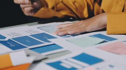 UX developer and ui designer brainstorming about mobile app interface wireframe design with customer breif and color code. business working