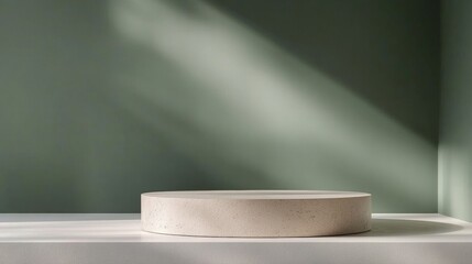 Poster - Minimalist round stone pedestal table against a soft green wall with elegant shadows for product display
